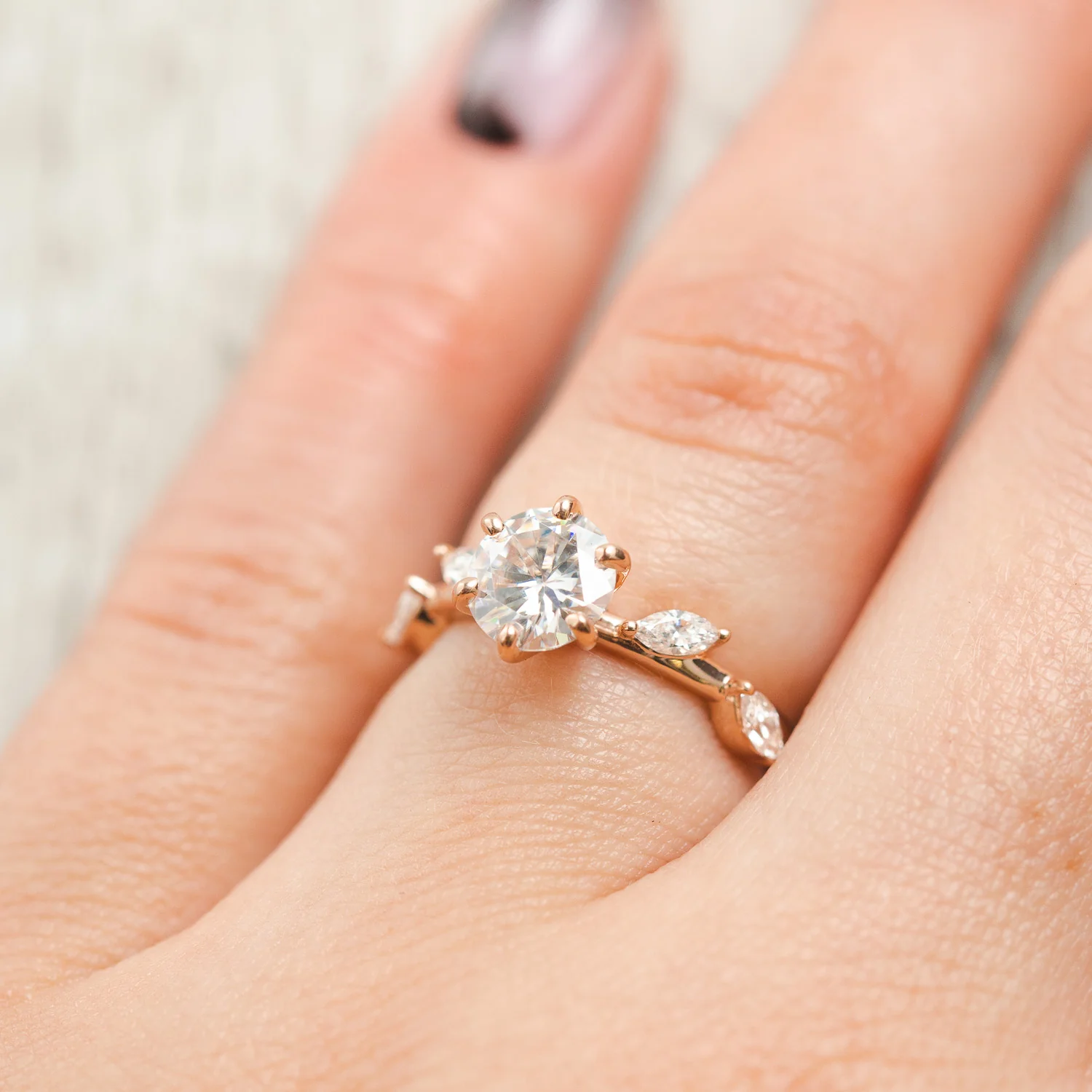 "FLORA" - ROUND CUT MOISSANITE ENGAGEMENT RING WITH MARQUISE CUT DIAMOND ACCENTS - Image 11